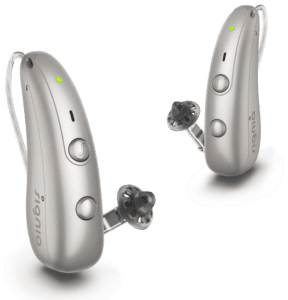Two silver receiver-in-canal hearing aids with thin tubes and black earpieces on a white background